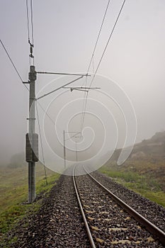 Railroad in the nature on a foggy morning