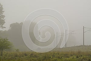 Railroad in the nature on a foggy morning