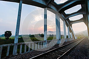 Railroad passed ancient the Tha Chomphu Bridge in the morning