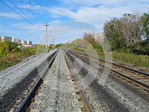 Railroad rails converge on the horizon