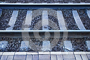 Railroad rails and paved peron top view