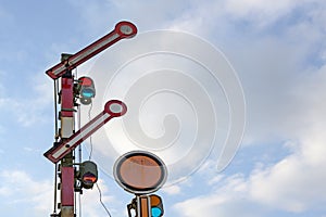 Railroad signal against the blue sky with clouds, copy space