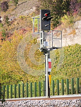 A railroad signal stands on red