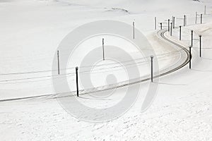 A railroad in the snow covered landscape in St Moritz Switzerland
