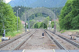 Railroad station featuring a view of the tracks extending in the foreground