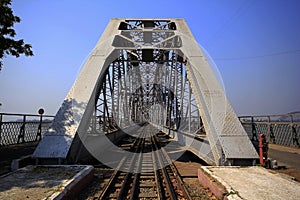 The railroad is on a steel bridge.