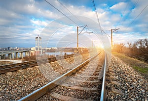 Railroad at sunset. Railway station against blue cloudy sky