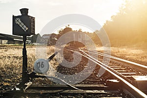 Railroad switch with train in the morning sun