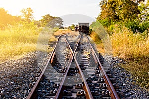 Railroad switch with train in the morning sun. The conception of