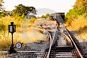 Railroad switch with train in the morning sun. The conception of