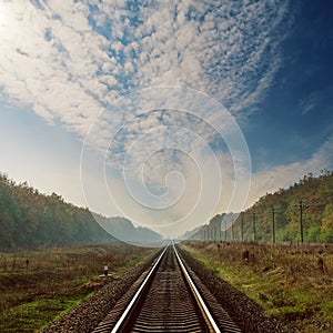 Railroad to horizon and dramatic sky