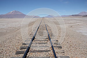 Railroad to nowhere in a stone desert