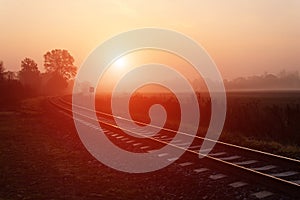 Railroad track during autumn foggy morning