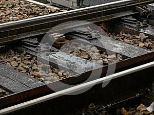 Railroad track detail, closeup, water on train tracks up close, old metal rails, railway in heavy rain. Sadness, melancholy