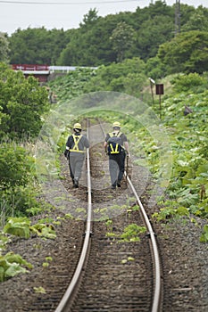 Railroad track maintenace people walking on rails of JR Hanasaki Line, Hokkaido, Japan