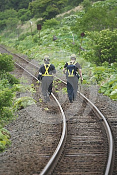 Railroad track maintenace people walking on rails of JR Hanasaki Line, Hokkaido, Japan