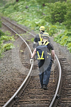 Railroad track maintenace people walking on rails of JR Hanasaki Line, Hokkaido, Japan