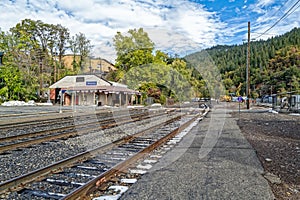Railroad tracks approach the Amtrak train station in Dunsmuir, California, USA - November 11, 2022