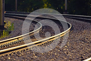 Railroad tracks lit by golden sunset light