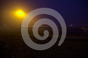 Railroad tracks on a foggy day at sunset