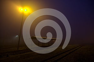 Railroad tracks on a foggy day at sunset