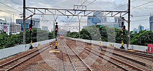 Railroad tracks with four tracks at Gambir station, Jakarta with traffic lights on each track.