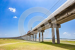 Railroad tracks with freight train passing the reservoir