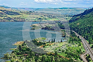 Railroad tracks and Interstate 84 run along the riverside in the Columbia River Gorge in Oregon, USA