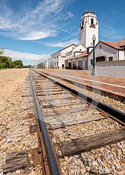 Railroad tracks lead past a local train depot