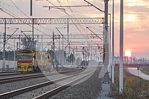 Railroad Tracks, Maintenance Train and Overhead Lines at Sunset