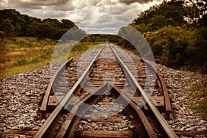 Railroad tracks in the middle of wildlife. Dramatic sky with clouds. horizontal layout