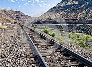 Railroad tracks of the Oregon Trunk Subdivision run along the Deschutes River near Tygh Valley, Oregon, USA