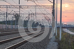 Railroad Tracks and Overhead Power Supply at Sunset