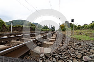 Railroad tracks and railroad ties leading straight to a far distance