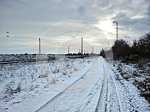 Railroad tracks and road in winterly Germany