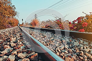 Railroad tracks with rocky tracks, looking far away to the evening sun