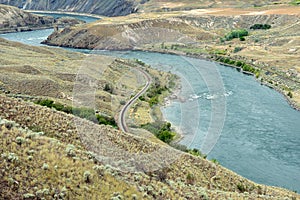 Railroad tracks run along both sides of the Thompson River near Ashcroft, British Columbia, Canada