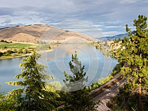 Railroad tracks running along Flathead river in Montana, USA