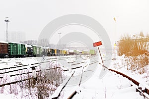 Railroad tracks in the snow. Commodity railway wagons, winter