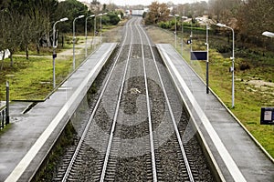 The railroad tracks stretch to the horizon and turn.