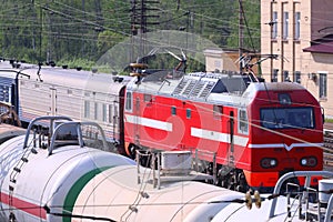 Railroad tracks with train with cisterns and passenger train