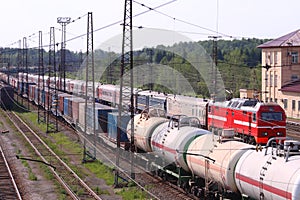 Railroad tracks with train with containers and cisterns and passenger train