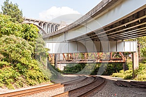 Railroad tracks under three bridges, an old rusted railroad bridge, the Braddock Avenue overpass and the East Pittsburgh bridge
