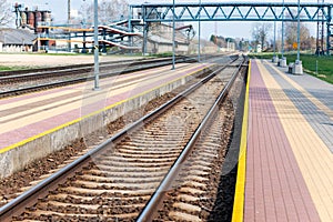 Railroad tracks urban shoot. Leading line view.iron rusty train railway over dark stones rail way