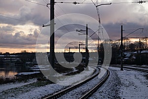 Railroad tracks in a winter foggy morning sprinkled with snow