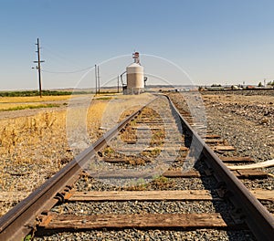 Railroad tracts lead to granary to collect grain for transport