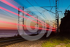 Railroad with train on background of sea