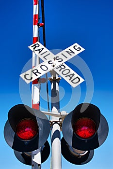 Railroad Train Level Crossing with Crossbuck Sign, gate and flashing red lights
