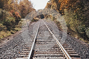 Railroad train tracks in rural Minnesota during the fall on a sunny autumn day