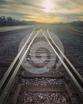 railroad train tracks at sunset desert